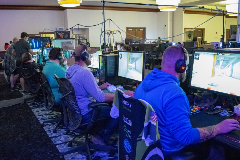 People playing games on computers at the LAN fest.